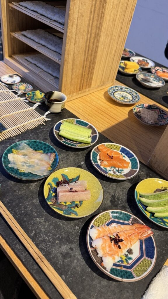 A colorful spread of ingredients for build-your-own temakizushi in small dishes at Kanazawa Temakizushi Coil.