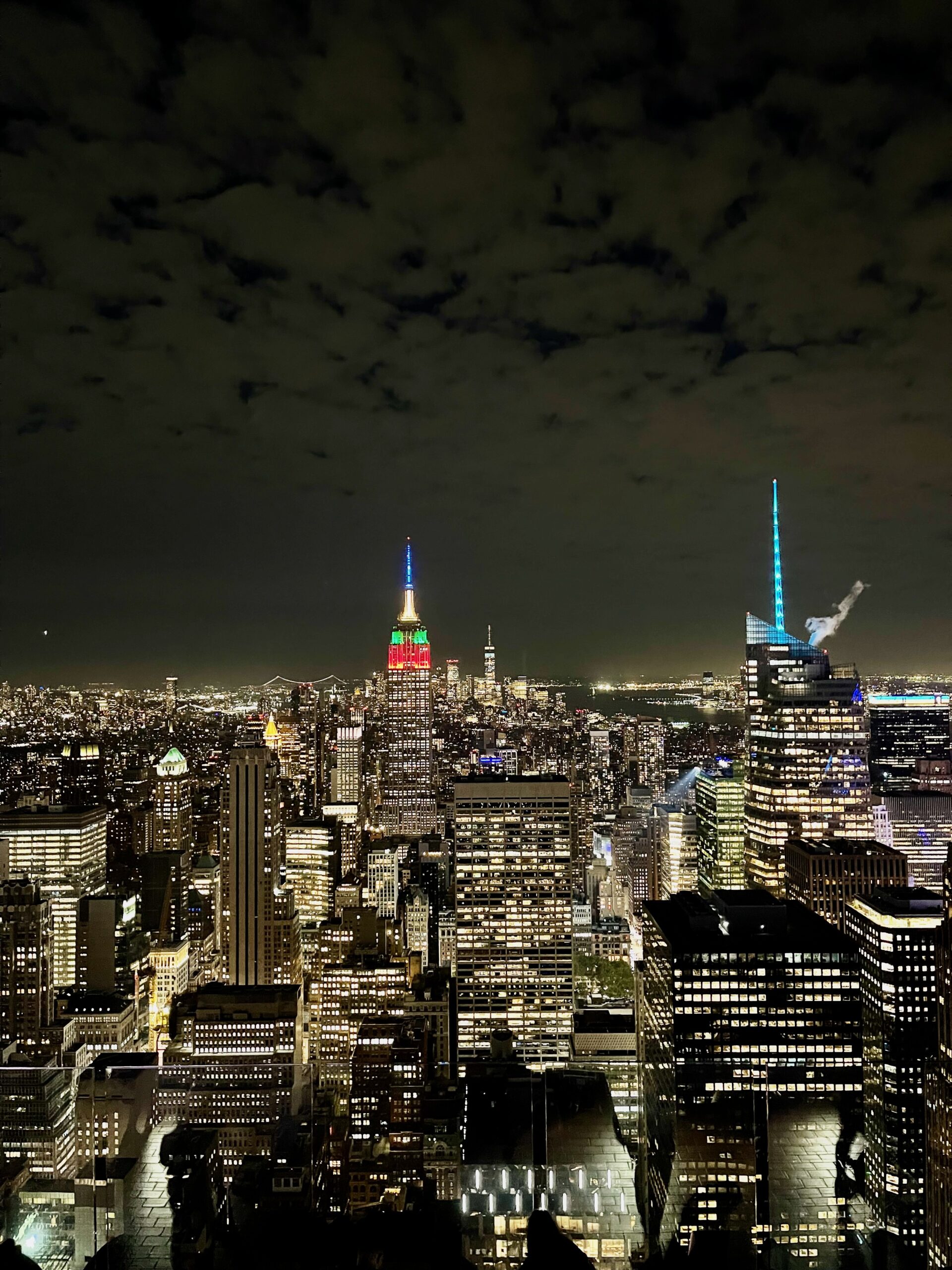 Night view from Top of the Rock toward the illuminated Empire State Building and Lower Manhattan.