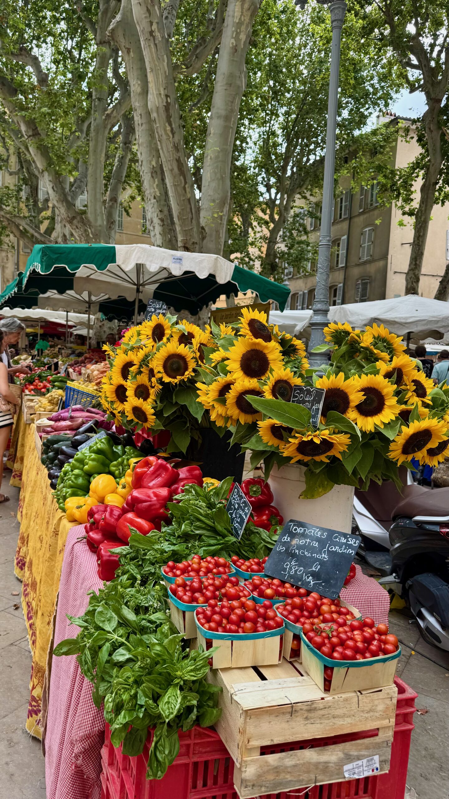 Market stalls spread across a square in the old town of Aix-en-Provence